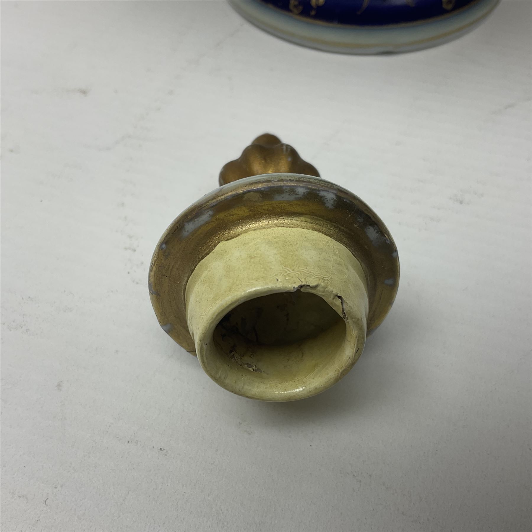 19th century Vienna style porcelain 'Musik' garniture, the central vase of baluster form with domed cover flanked by two smaller vases with twin curved gilt handles to short neck, each decorated with classical figural vignettes between blue borders heightened with gilt, H33.5cm