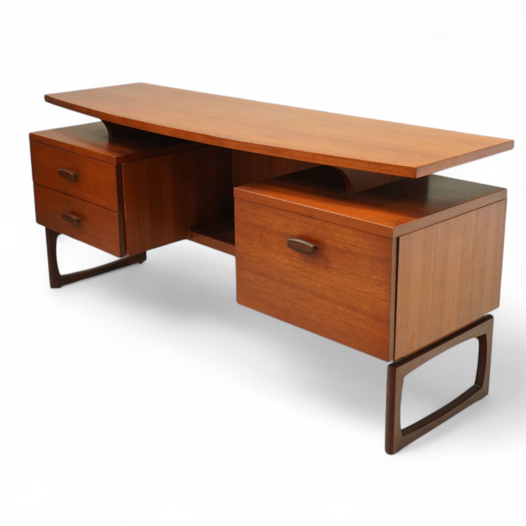 R Bennett for G Plan - mid-20th century teak 'Quadrille' desk or dressing table,  shaped platform rectangular top above rectilinear open base above four drawers with sculpted handles, on rectangular frame supports 