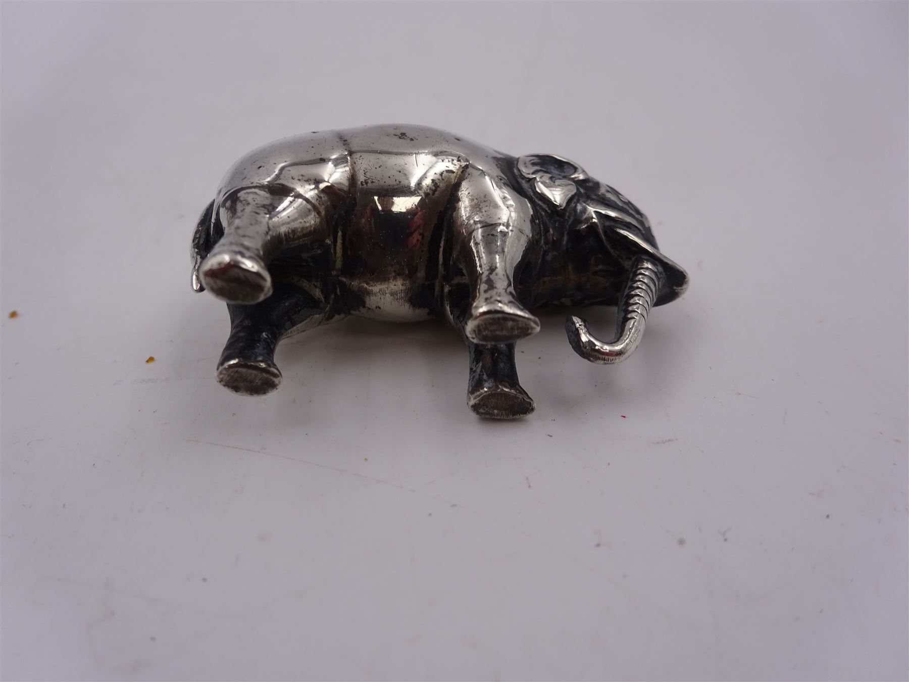 Edwardian silver mounted novelty pin cushion, in the form of an elephant, with cushioned back, hallmarked Birmingham 1906, maker's mark worn and indistinct, L4cm, H3.5cm