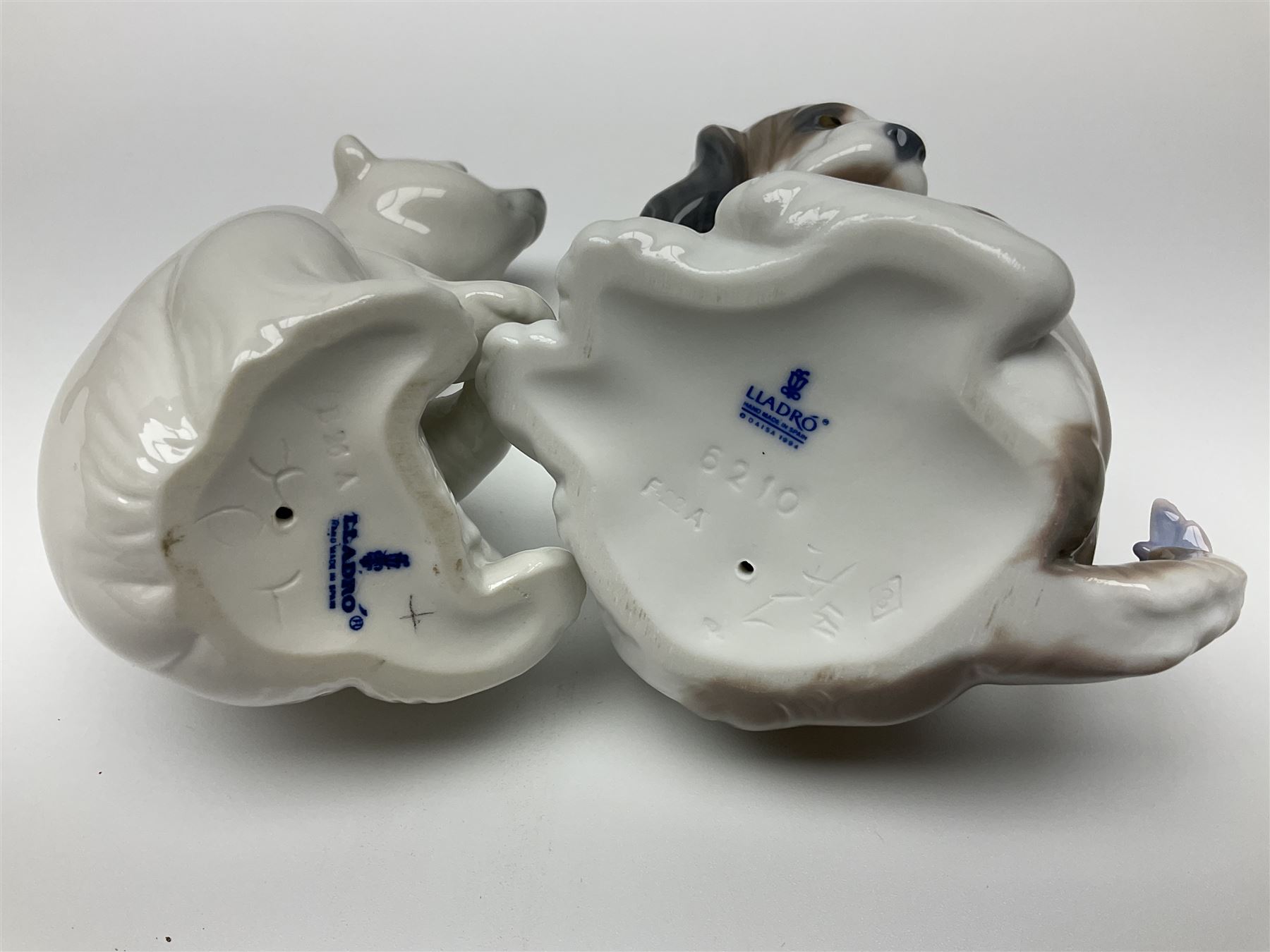 Five Lladro figures, comprising Cat and Mouse no. 5236, That Tickles no. 5888, Gentle Surprise no. 6210, Little Hunter no. 6212 and Resting Polar Bear no. 1208, largest H12cm