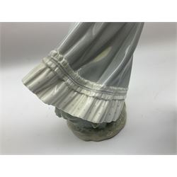 Three Lladro figures, comprising, Dreams of Summer Past no 6401, Spring Breeze no 4936 and Breezy Afternoon 5682 together with Lladro plaque Art Brings us Together no 7677, all in original boxes, largest example H35cm