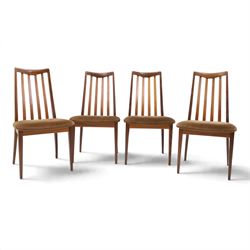 G Plan - Mid 20th century teak extending dining table and four chairs, oval top with stowed fold-over leaf extending to 208cm, raised on two shaped supports united by a stretcher 