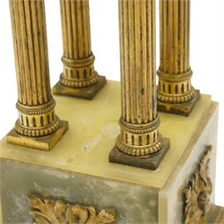 Neoclassical onyx and brass jardinière or plant stand, circular onyx top over an acanthus gilt frieze, supported by for fluted composite columns, square plinth with applied rosette mounts and stepped base, raised on scroll feet  