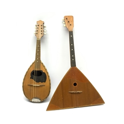 Italian lute back mandolin with black lacquered segmented rosewood back and spruce top L64cm; together with a Russian three-string balalaika of typical triangular form with faceted back and spruce top, bears label, L70cm (2)