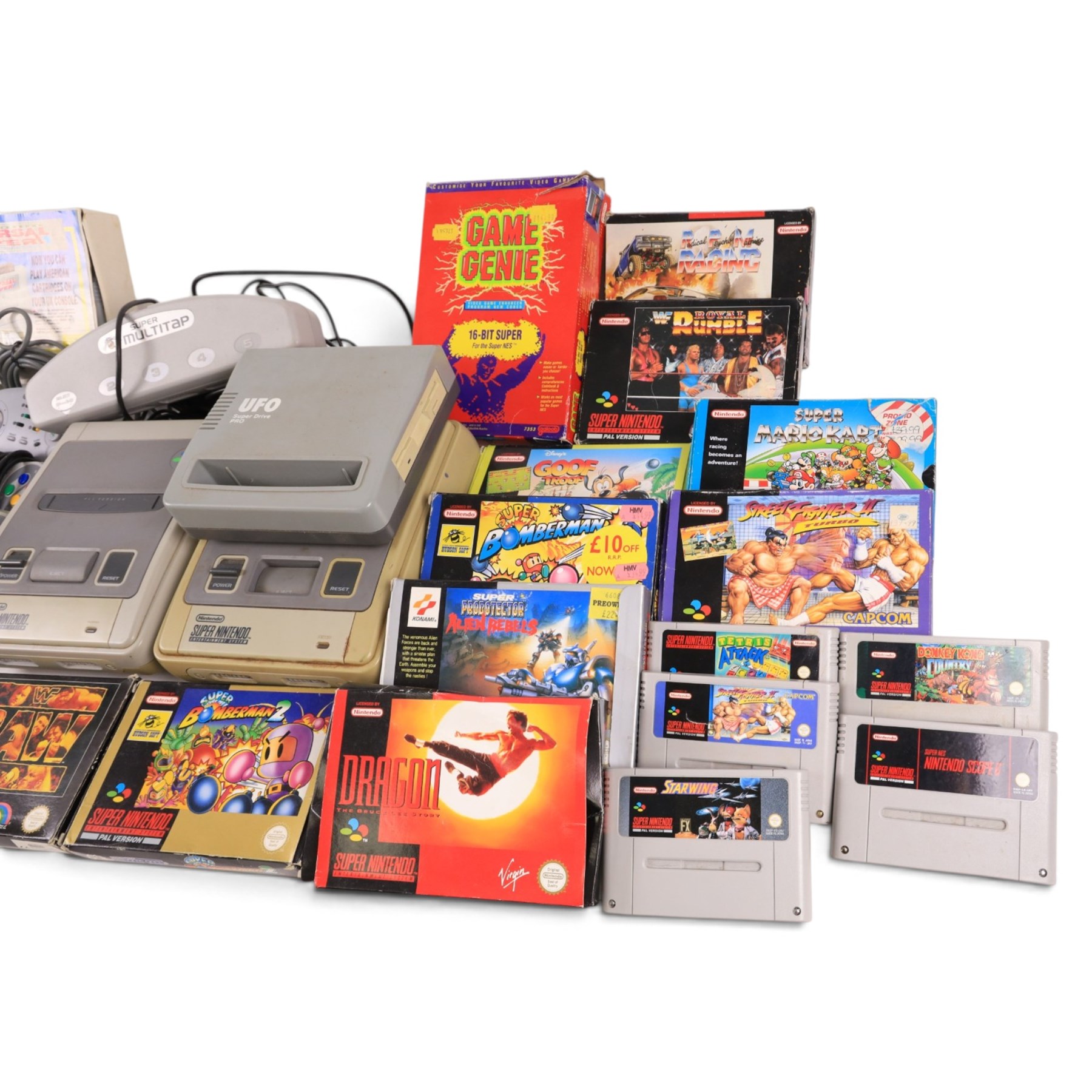 Two Super Nintendo Entertainment System consoles, accessories to include Super Multitap, UFO Super Drive Pro, Universal Adapter, Game Genie, Scope 6 accessories (Scope not present), seven controllers including one Competition Pro and a SN Pro Pad and fifteen SNES games comprising eleven boxed and four unboxed examples, titles to include Dragon The Bruce Lee Story, Street Fighter II Turbo x2 (one unboxed), Royal Rumble, Super Mario Kart, Radical Psycho Machine Racing, Super Bomberman, Super Bomberman 2, Protector Alien Rebels, Double Dragon, Goof Troop, WWE Raw Wrestling, Tetris Attack, Donkey Kong Country and Starwing