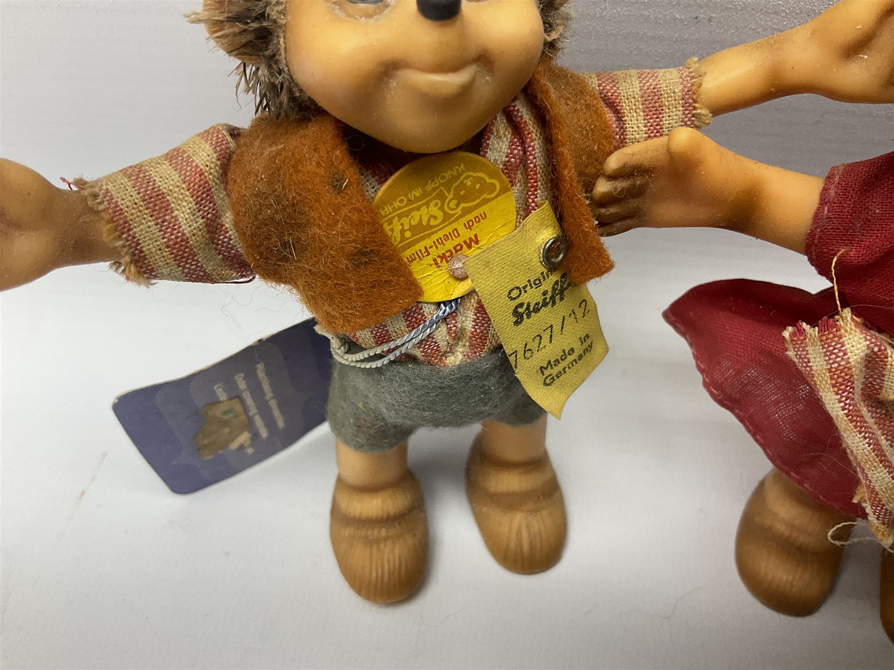 Group of Steiff figures, comprising Mikki and Mukki, circa 1950s no 7628/12 and 7627/12, with original tags, two hedgehogs no 1570/10, and another smaller 1670/03, small owl no 7480/06, and painted metal Steiff harlequin style bear