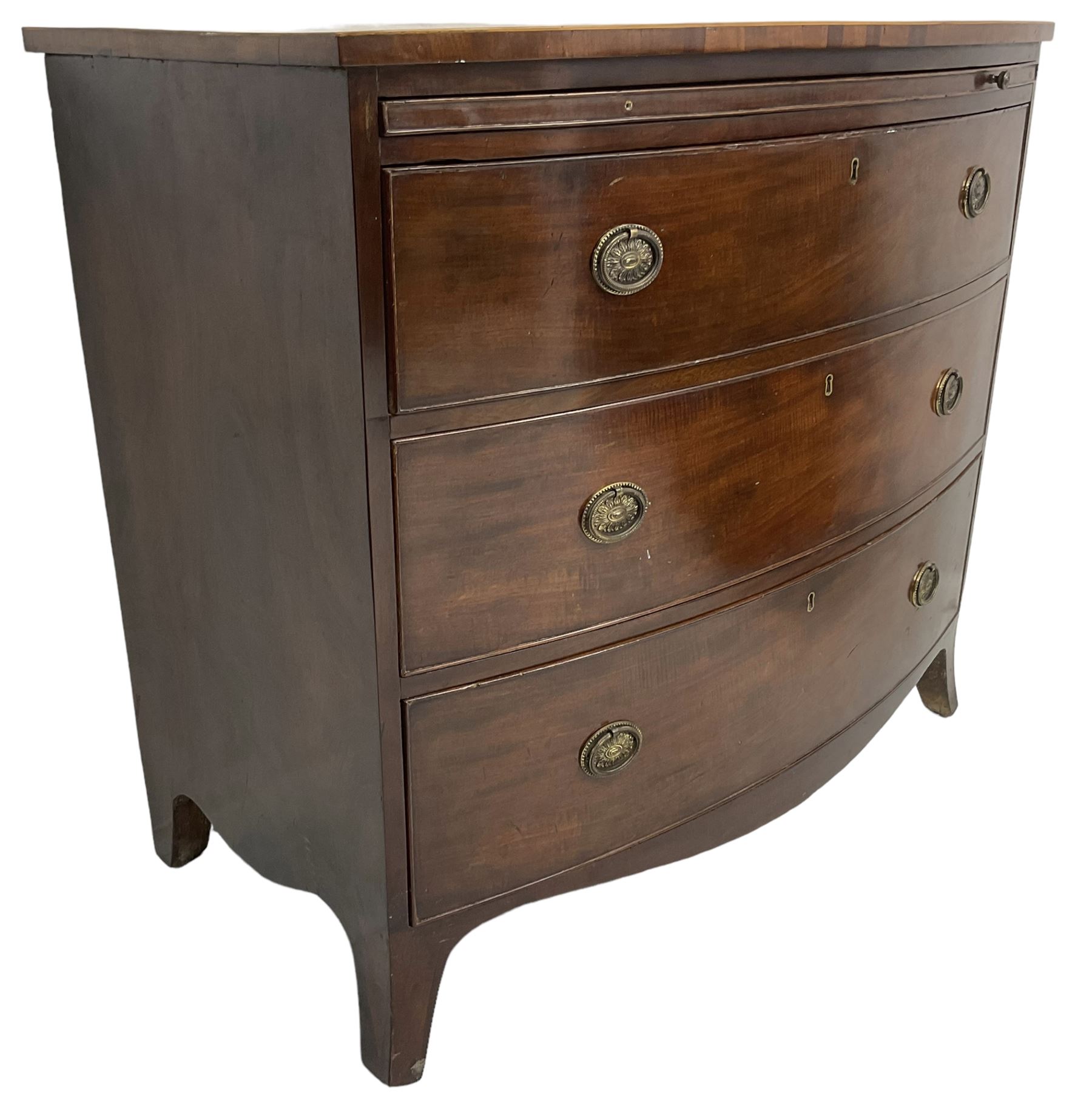 George III mahogany bow-front chest, shaped top with satinwood stringing, fitted with brushing slide over three graduating cock-beaded drawers, shaped apron over bracket feet