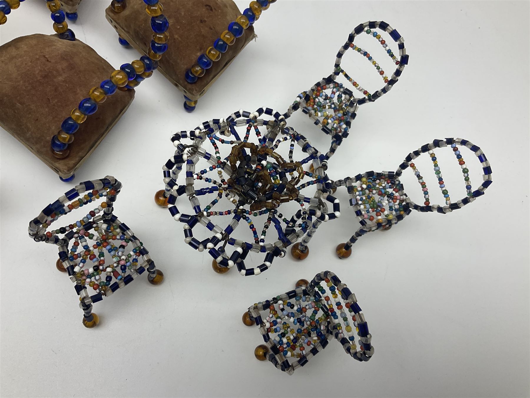 Quantity of early 20th century doll's house furniture comprising Victorian style beadwork and upholstered eight-piece salon suite; beadwork dining table with four matching chairs; and Kleeware brown plastic seven-piece dining suite