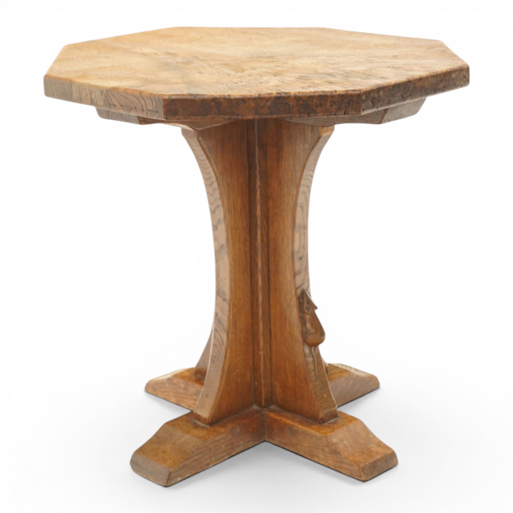 Mouseman - early 20th century adzed and figured burr oak coffee table of small proportions, the octagonal lightly adzed burr top raised on cruciform base and sledge feet, carved with tall mouse signature, by the workshop of Robert Thompson of Kilburn 