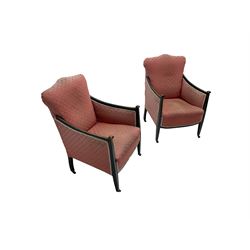 Pair early 20th century armchairs, ebonised frame with ivorine inlay, upholstered in pink fabric with fan design and sprung seat, on brass and ceramic castors