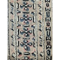 Persian design pale pink ground rug, the field divided into panels and decorated with Gul motifs, wide multi-band border with geometric patterns 
