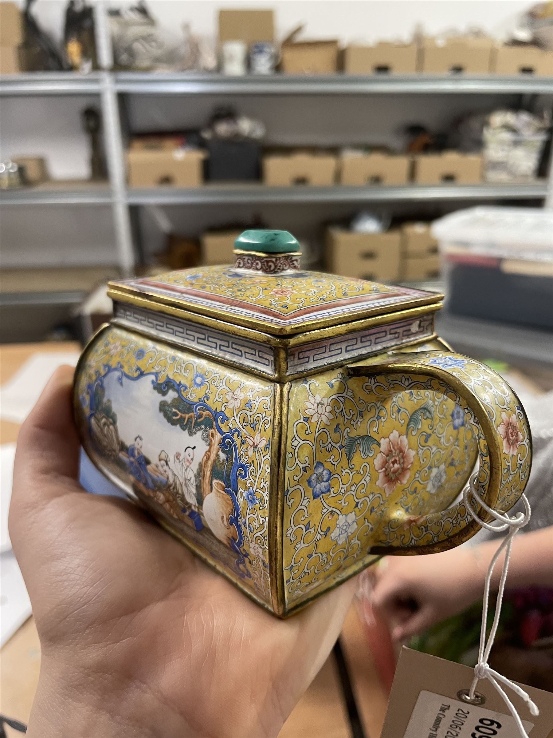 Chinese Qianlong enamel bombé shaped teapot, decorated with scenes of scholars examining a scroll and drinking on a yellow ground with various traditional floral and foliate motifs, the painted scene framed within trailing blue vine border, with Qianlong marks to base L15cm