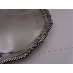 Modern silver salver, with shaped oblique gadrooned rim, upon three scroll feet, hallmarked E H P Co Ltd, Sheffield 1976, D31cm
