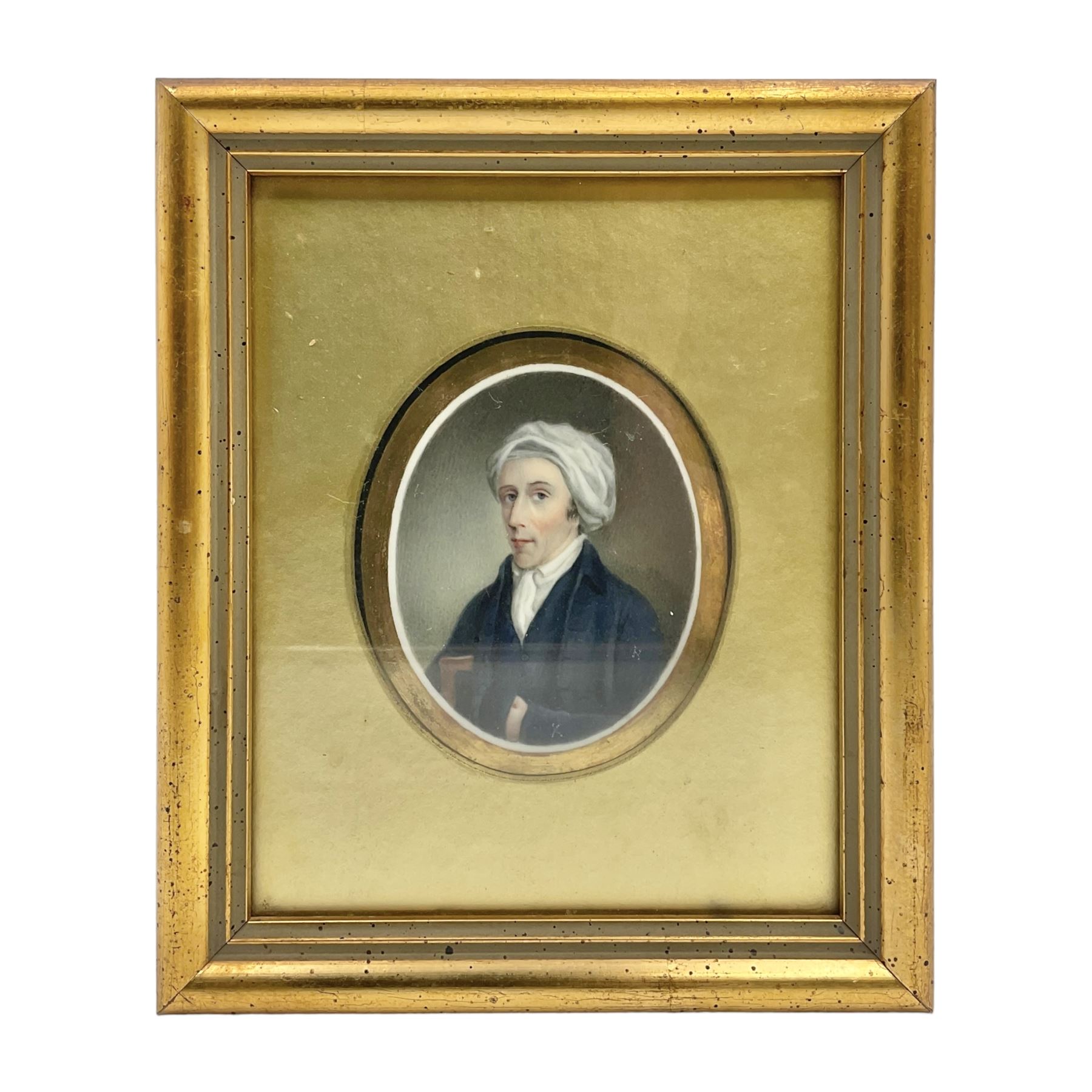 English School (18th century)
Portrait miniature upon ceramic plaque 
Head and shoulder portrait of a gentleman in blue coat and white turban, holding book under one arm
Indistinct inscription verso
Within gilt mount and gilt frame under glass
Portrait 7cm x 5.5cm 
Plaque 14cm x 11.5cm
Frame 16cm x 13.5cm