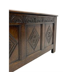 18th century oak coffer or chest, rectangular triple panelled hinged top with moulded edge enclosing main compartment and candle box, the frieze carved with repeating concentric lunettes and foliate patterns, the front fielded panels decorated with lozenges containing central flower heads, on stile supports