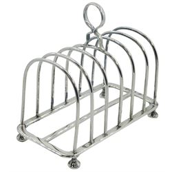 Edwardian silver seven bar toast rack, of plain curved form with central ring handle, upon four compressed bun type feet, hallmarked William Hutton & Sons Ltd, London 1906, L13.5cm, approximate weight 6.2 ozt (193 grams)