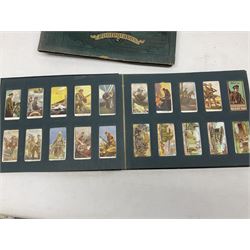 Three albums of cigarette cards including Wills Recruiting Posters, Military Motors and Allied Army Leaders, cricketers etc; another album containing a large quantity of laid-in cigarette cards; and an album of thirty-seven postcards of dogs by Mac (5)