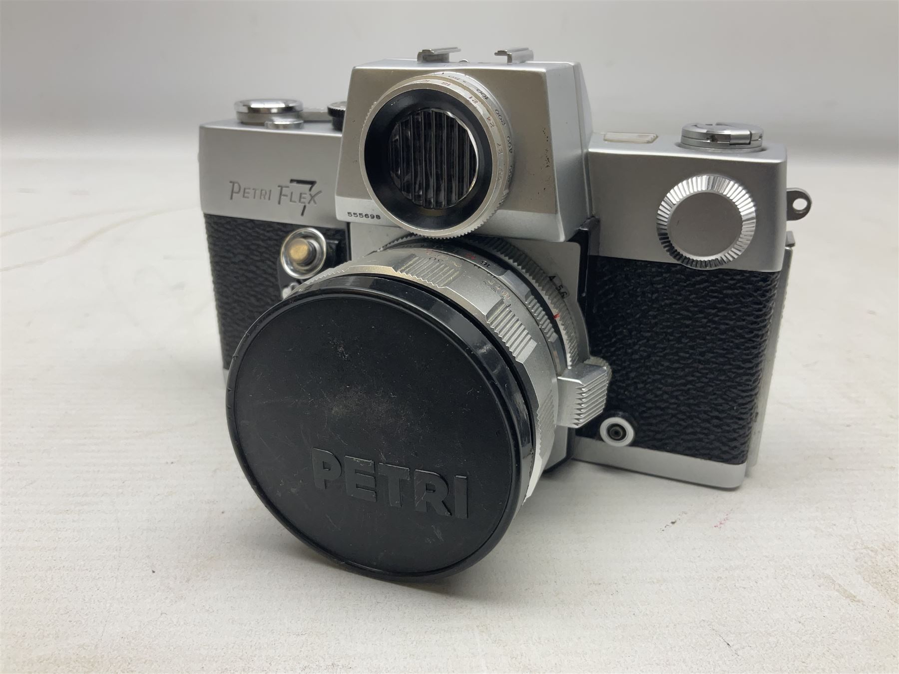 Petri Flex 7 camera body, serial no. 555698, with Perti C.C 1:1.8 f=55mm' lens, serial no. 78253, together with Petri Flex V2 camera body, serial no. 364427, with 'Petti C.C. 1:2 f=55mm' lens, serial no. 137076, in ever ready case