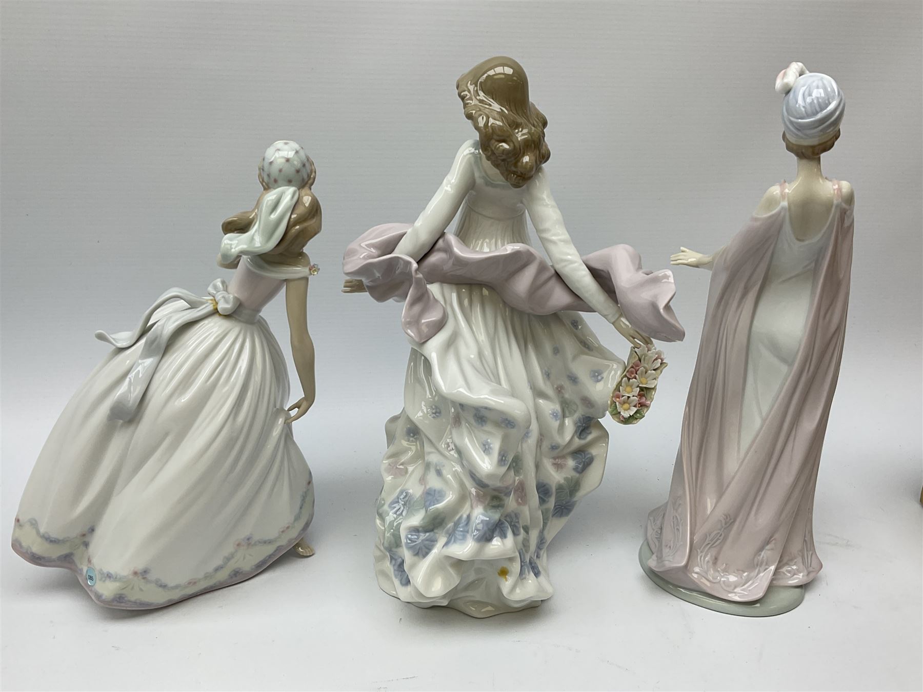 Large Lladro Figures, Spring Splendor, designed by Regino Torrijos, model number 5898, H30.5cm, the glass slipper, designed by Jose Puche, model number 5957, H29cm and Breathless, designed by Juan Ignacio Aliena, model number 6430, H31cm.