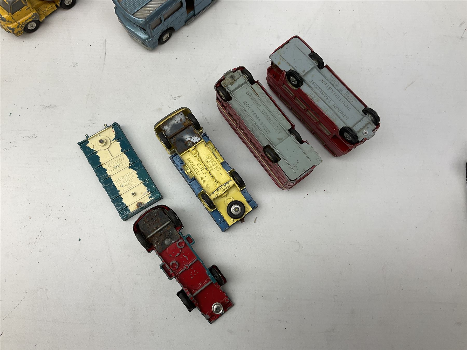 Corgi - eighteen unboxed and playworn/repainted die-cast commercial vehicles including Commer 5-Ton Wagon with drop-side trailer and two other 5-Ton wagons, Dodge Key Fargo, Jeep FC-150, two London Routemaster buses, Carrimore Trideck Transporter, two Carrimore Mark IV Transporters, Carrimore Low Loader, Ecurie Ecosse Racing Car Transporter etc (18)
