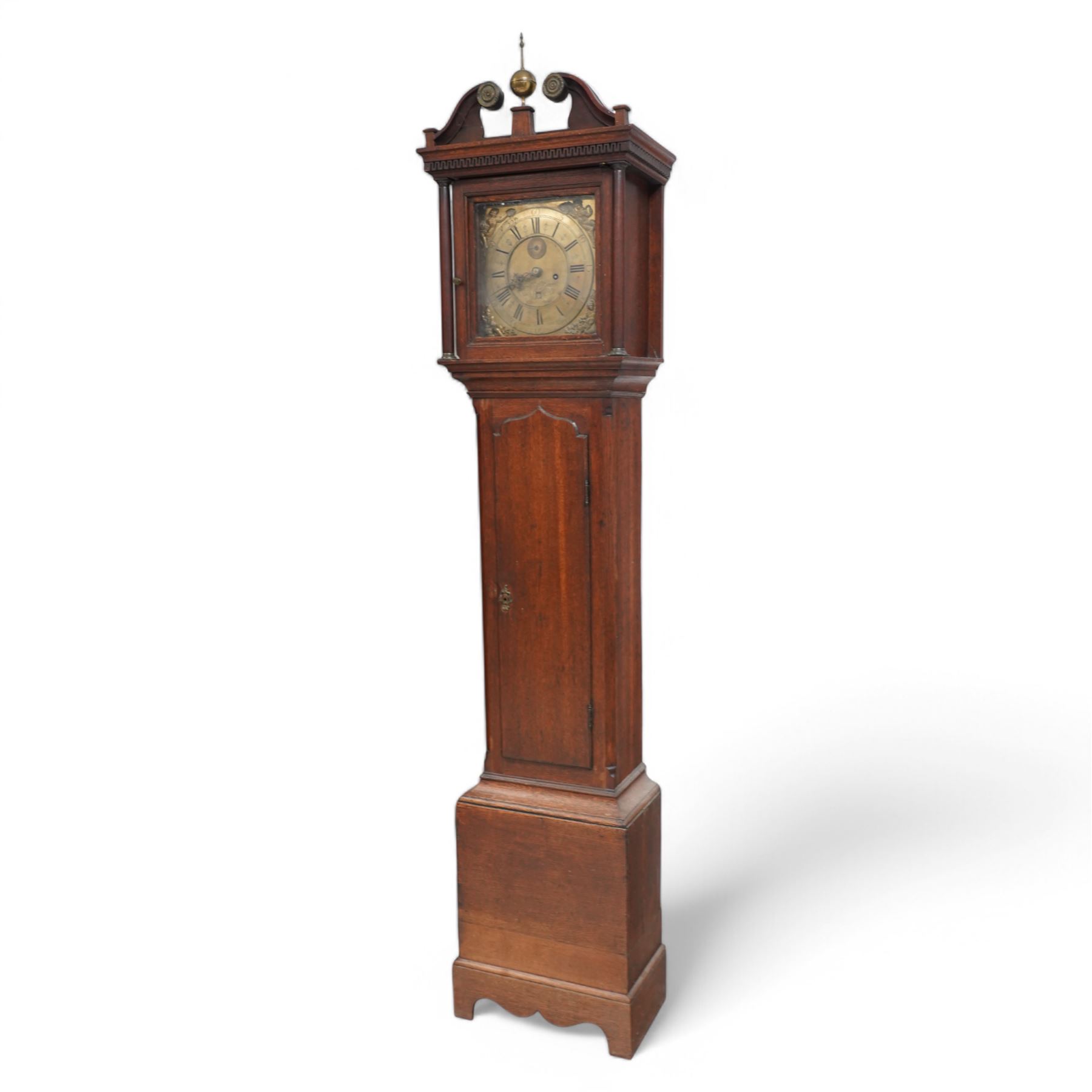 Thomas Holme of Hexham- mid 18th century 8-day oak longcase clock with a swan necked pediment and ball and spire finial to the centre, square hood door flanked by turned pilasters with brass capitals, trunk with canted corners and a long door with a gothic arched top, square plinth raised on an applied skirting, brass dial with 