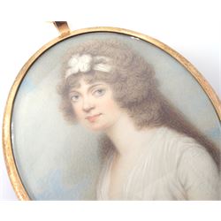Henry Bone RA (British 1755-1834)
Portrait miniature upon ivory, circa 1785
Head and shoulder portrait of Lucia Maria Young, wearing white dress
Signed H Bone
Within gilt frame with blue enamel and hair work panel with seed pearl initial 'L' to centre verso 
Oval 7cm x 6cm

Lucia Maria Young was the eldest daughter of Admiral Sir George Young. Lucia would have been around twenty years old at the time this miniature was painted. 

During his early career Henry Bone worked as a porcelain and jewellery painter, and exhibited regularly the Royal Academy as an elected Royal Academician. 
He was appointed as Royal Enamelist to King George III, George IV and William IV. 
Due to the quality of his work Bone is said to have been known as the 