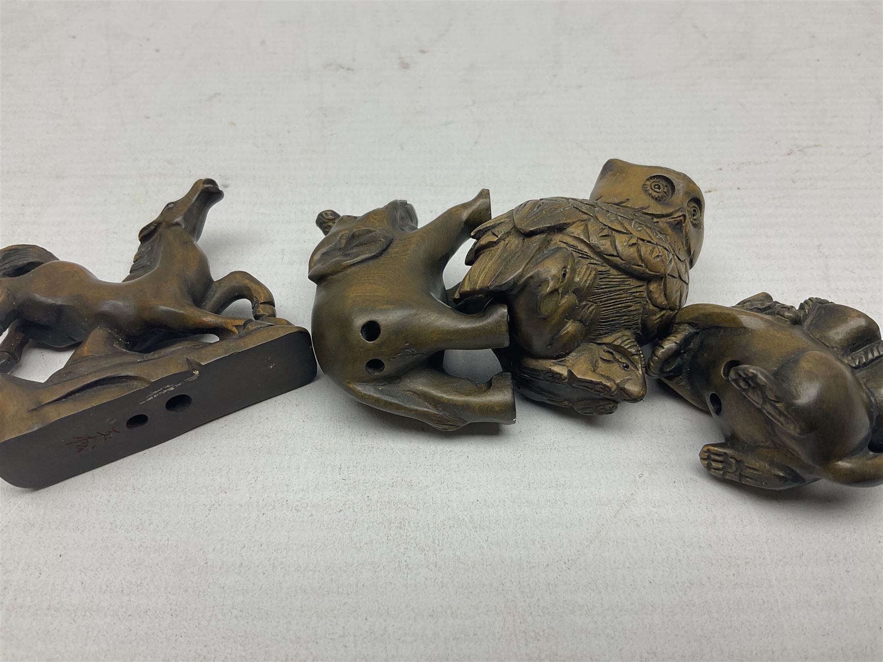 Eight netsuke, modelled as a rabbit, rat, elephant, rhino, dog, owl, penguin and horse