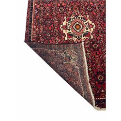Persian red ground rug, all over patterned field