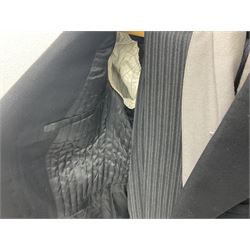 Two gentlemen's vintage black morning jackets, together with pair of suit trousers and waistcoat, and a black mess jacket with label detailed 'Made expressly for Johnsons (Hull) Ltd', (3)