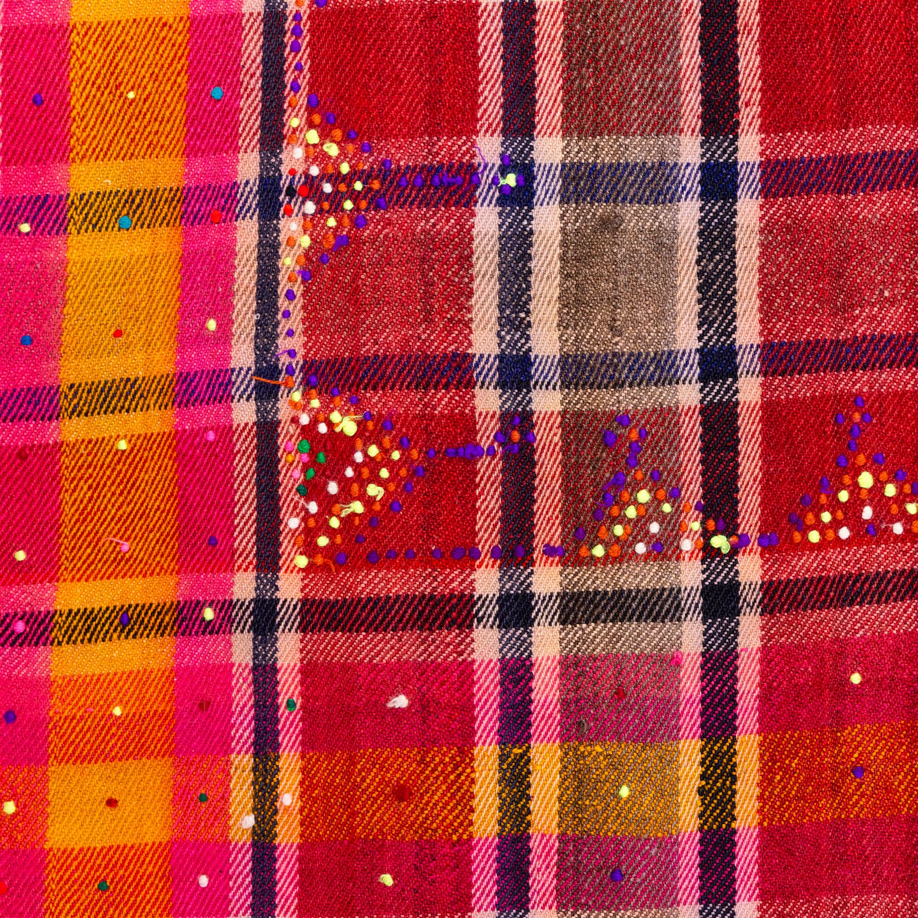 South West Persian Jajim kilim, field woven with a plaid design of intersecting bands in shades of red, terracotta, pink, and ochre, flanked by contrasting side panels decorated with small geometric tribal motifs the decoration incorporating raised wool details against flatwoven ground  