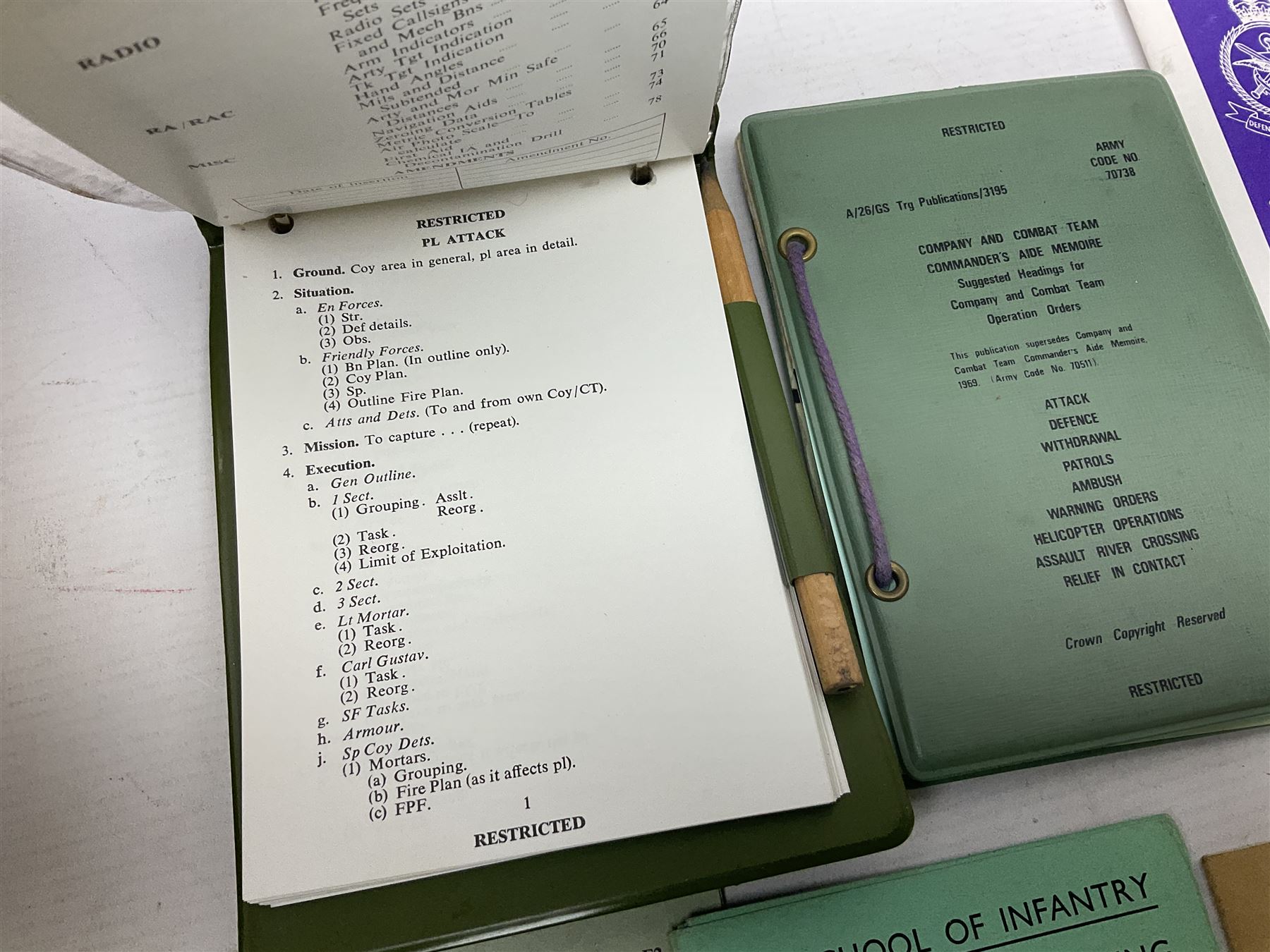 Collection of nineteen British Army booklets 1940s - 1970s including Small Arms Training 1944, various Infantry Training, Cadet Training Manual 1978, Signal Training, Commander's Aide Memoires etc; 1950s blue beret with Yorks Brigade badge; part travelling toilet set in cloth roll; all contained in pine box with webbing straps