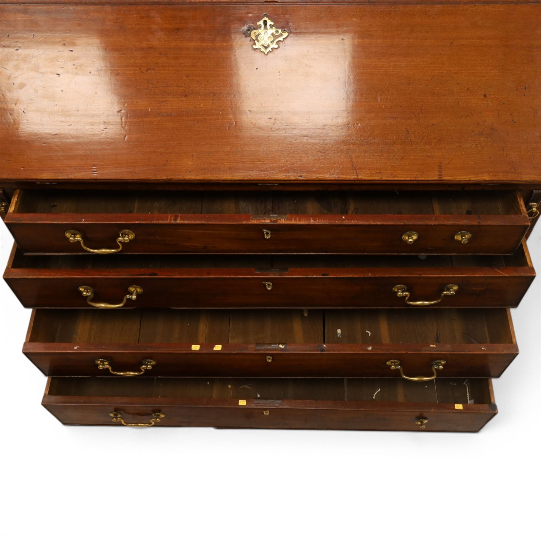George III mahogany bureau of large proportions, the fall-front enclosing fitted interior with fluted column secret compartments and assorted pigeonholes and correspondence drawers flanking central cupboard, over four graduating cock-beaded drawers with original brass swan-neck handles, raised on bracket feet