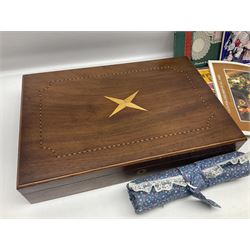 Collection of lace making wooden bobbins, together with lace making books and a handmade storage box