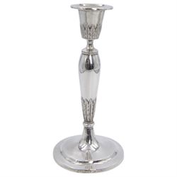 Pair of continental silver candlesticks, probably German Hanau, each of tapering form, with fern leaf decoration, upon a stepped circular base, with Hanau marks and assay scrape to base, H19cm