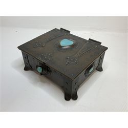 Arts and Crafts copper box, the lid decorated with stylised riveted hinges and inset with Ruskin type ceramic turquoise heart-shaped cabochon, the mount etched M.B 1913, and further cabochon roundel to each side panel, including one inset to the clasp acting as the knob to the locking mechanism, marked RS Douglas 1913 beneath, W16.5cm H7cm D15cm
