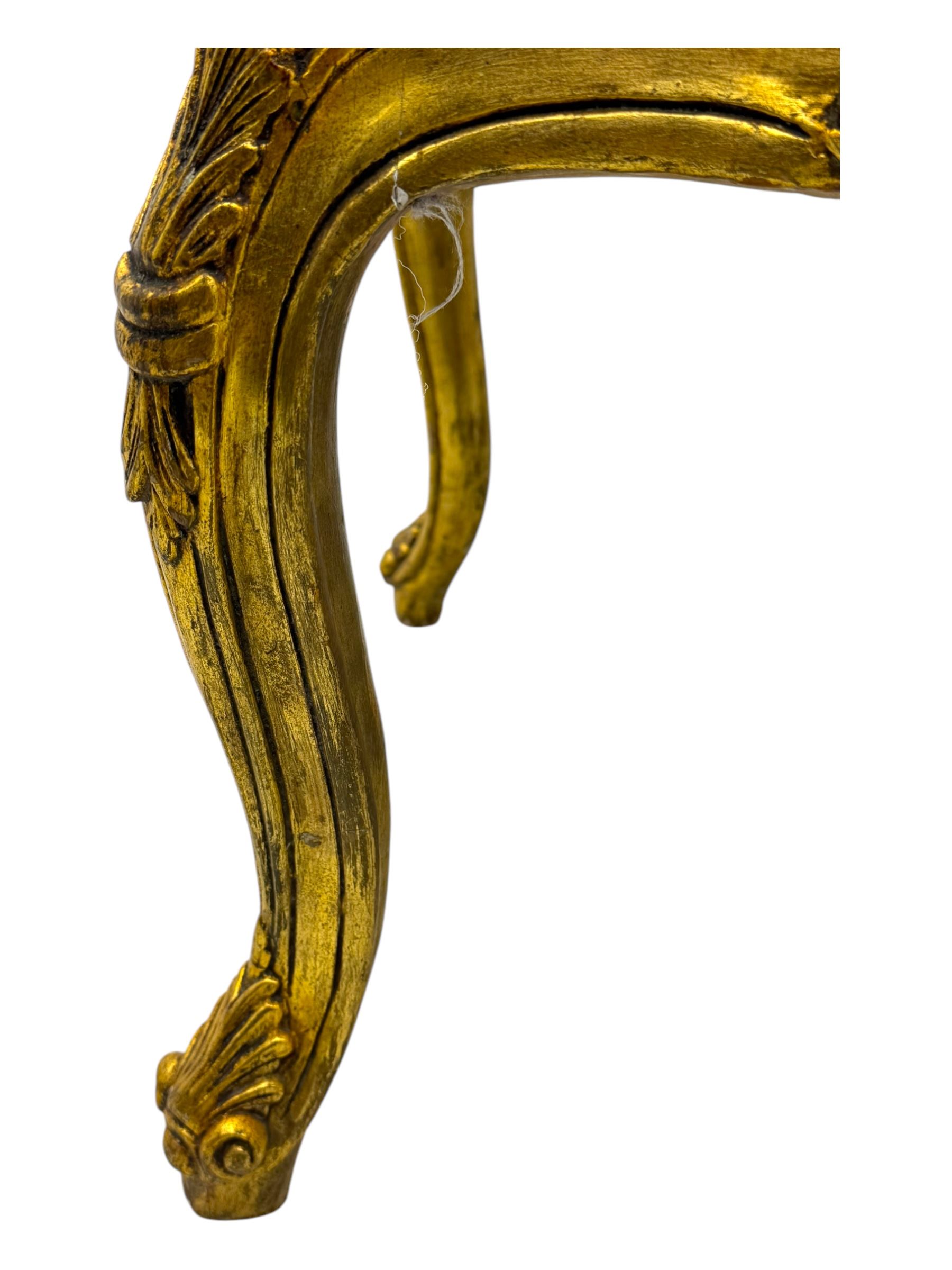 Pair of Louis XV-design giltwood stools, each upholstered in red damask fabric with slight variations in patterns, the carved frames adorned with scrolling foliage and shell motifs, raised on cabriole supports