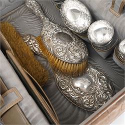 Ladies Edwardian crocodile travelling toilet case with watered silk interior containing six silver mounted glass jars Birmingham 1909 Maker Neal Bros. and a three piece dressing table set Sheffield 1898 W35cm