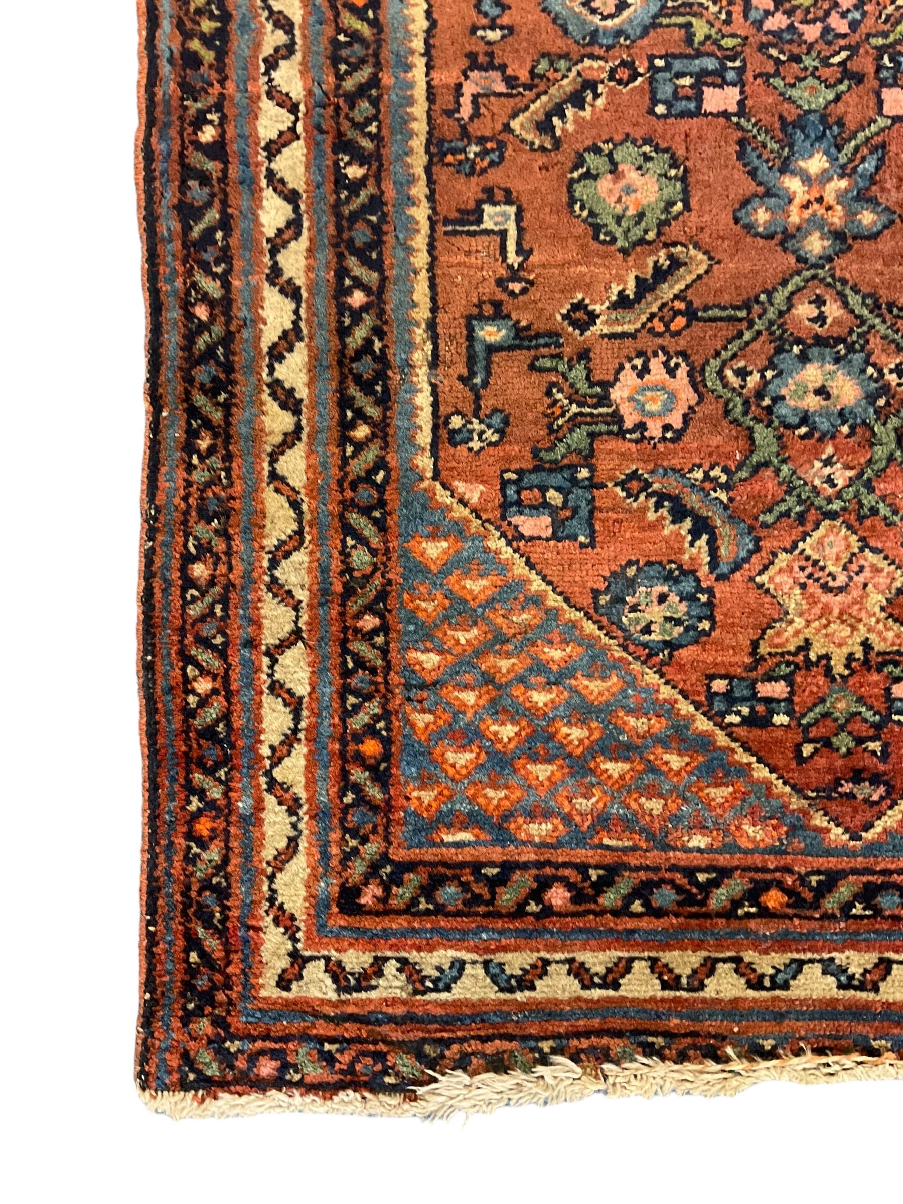 Small Persian rug or mat, decorated with Herati motifs within pattern borders 