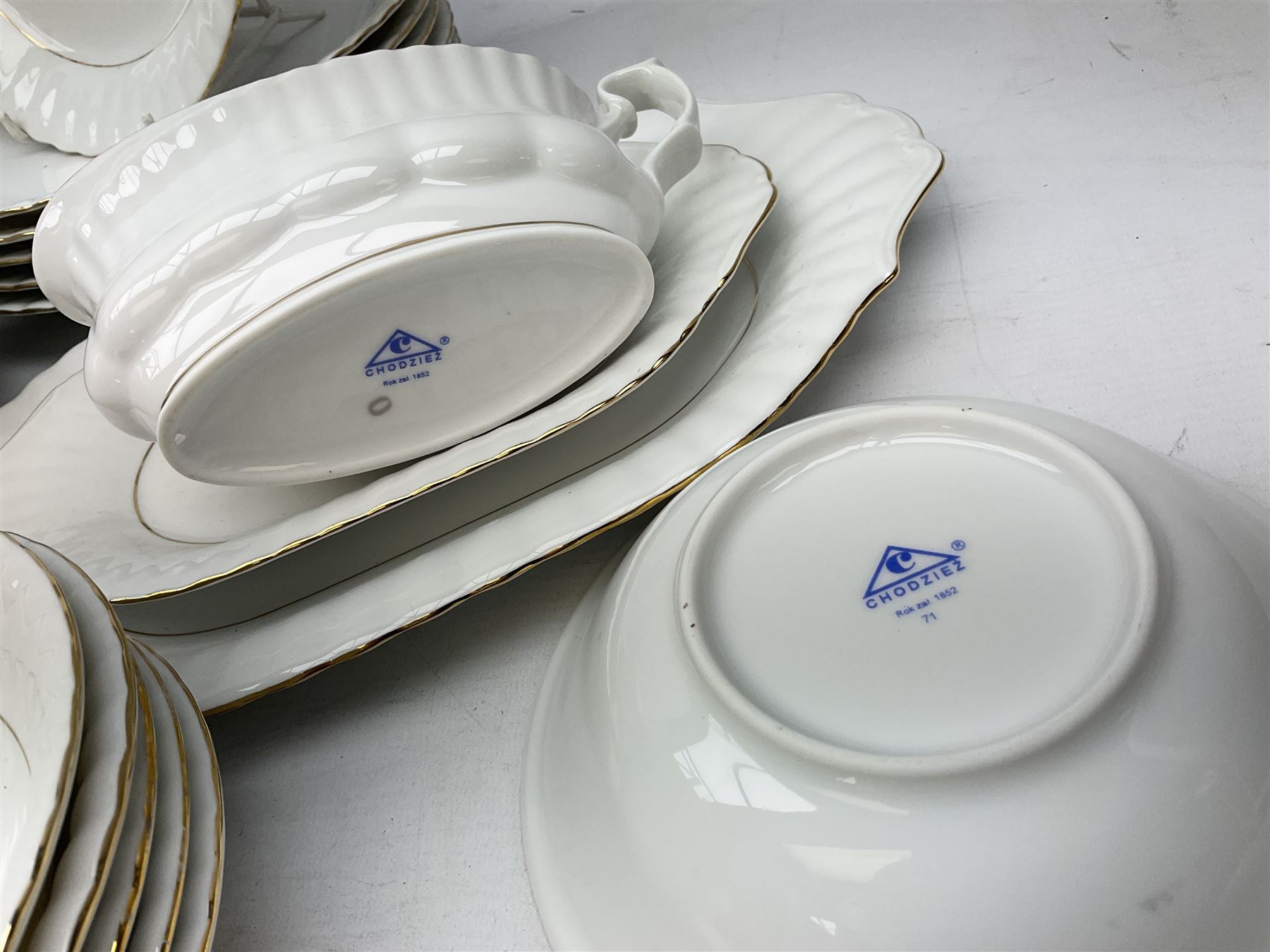Chodziez Polish dinner wares decorated in white and gilt to include lidded twin handled tureens, bowls, plates etc