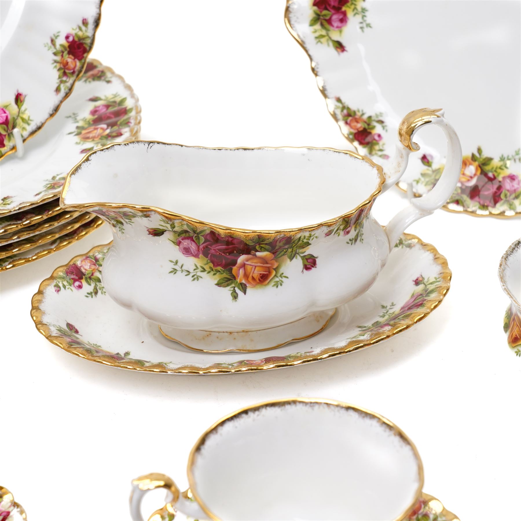 Royal Albert Old Country Roses tea and dinner ware comprising six dinner plates, five dessert bowls, sauce boat and stand, four breakfast cups and saucers, three tea cups and four saucers, six tea plates, milk jug, sugar bowl and bread and butter plate