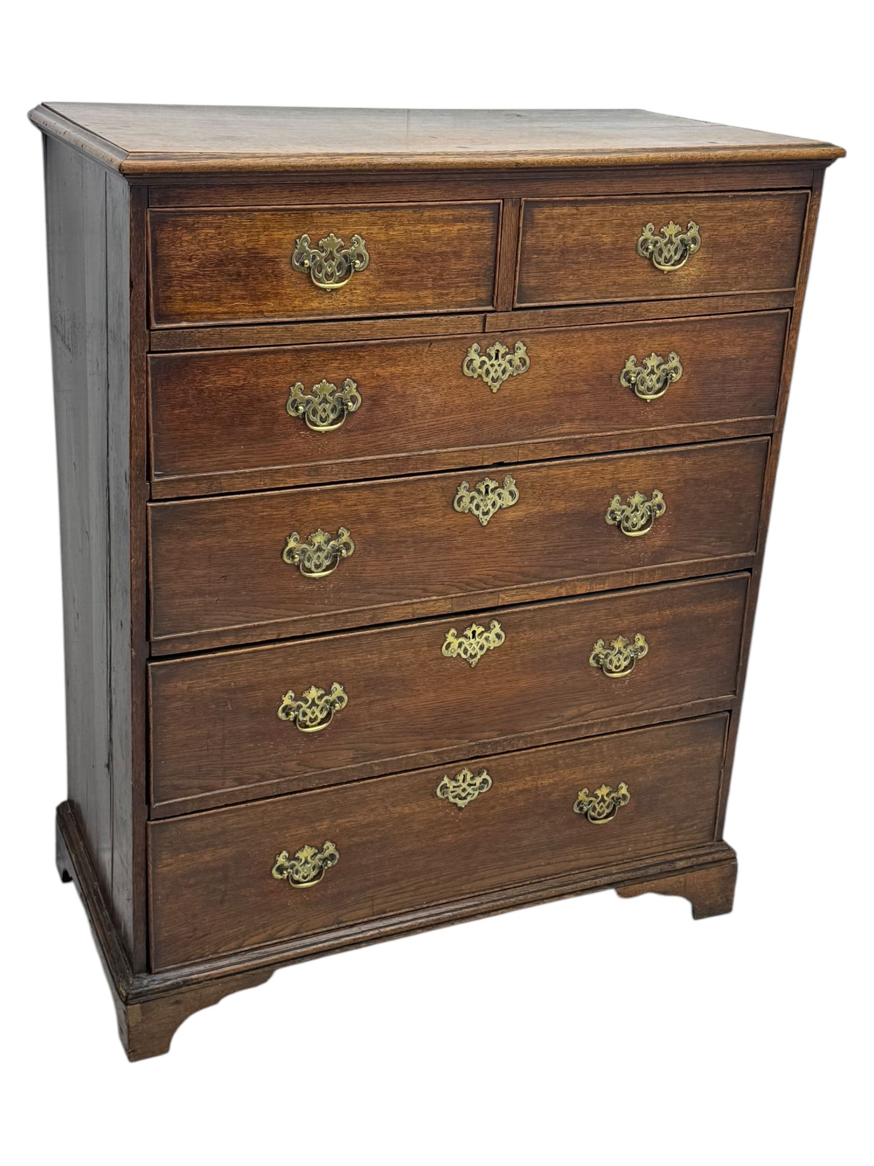 George III oak chest of drawers fitted with two short over four long drawers fitted with swan neck handles, supported on bracket feet