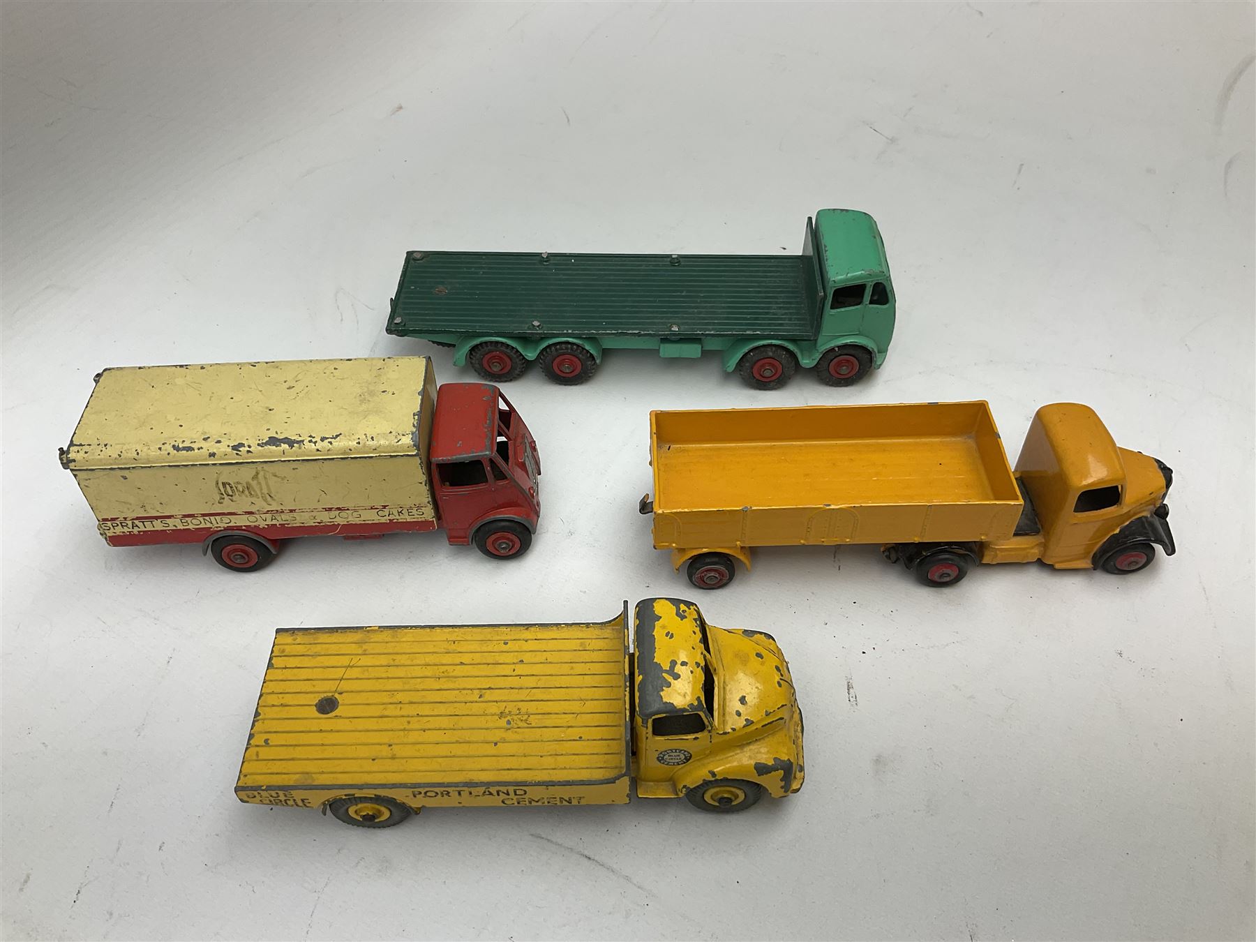 Dinky - eight unboxed and playworn/repainted commercial vehicles including Foden flatbed lorry, Bedford Articulated lorry, Leyland Comet Ferrocrete lorry, Guy Spratts panel van, Fire Engine, Jones Fleetmaster, Commer breakdown truck etc (8)