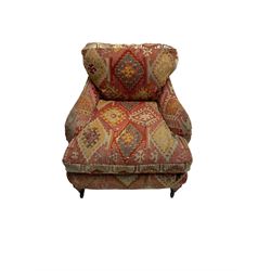 Early 20th century Howard style armchair, upholstered in Kilim fabric with sprung seat, hardwood frame, square tapering supports with brass and ceramic castors