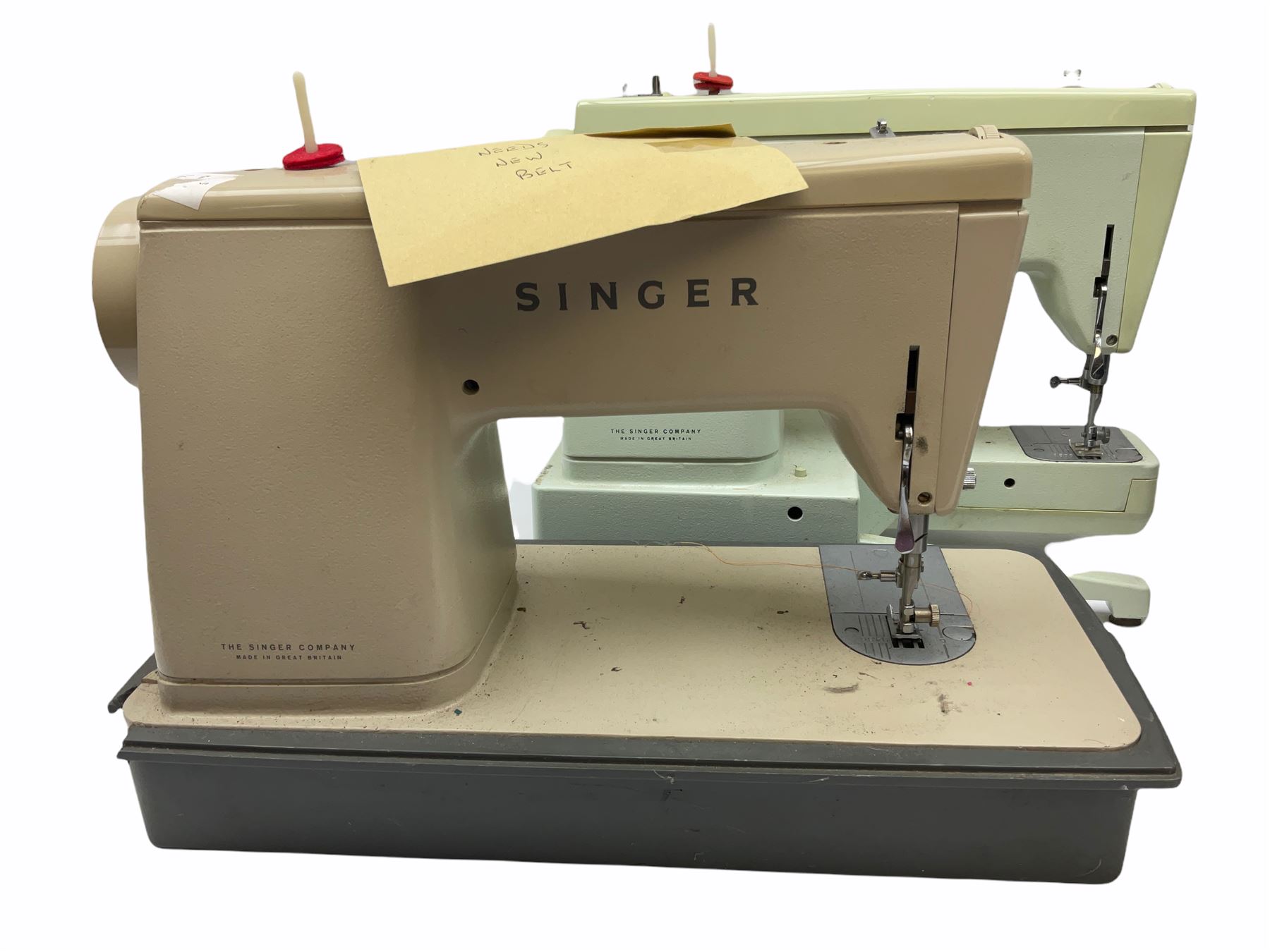 Two Singer sewing machines, model numbers 527 and 457, together with various Singer sewing machine parts, and a selection of sewing related accessories, to include threads, sewing needles, etc. 
