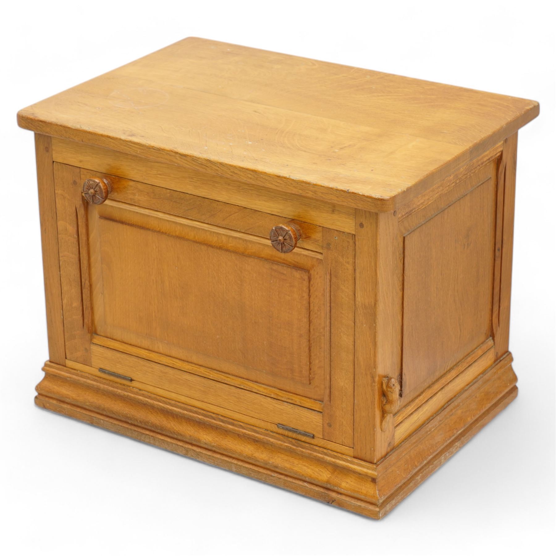 Beaverman - oak media stand, rectangular top over panelled hinged front fitted with Yorkshire rose carved handles, on moulded skirt base, carved with beaver signature, by Colin Almack, Sutton-under-Whitestone Cliffe, Thirsk