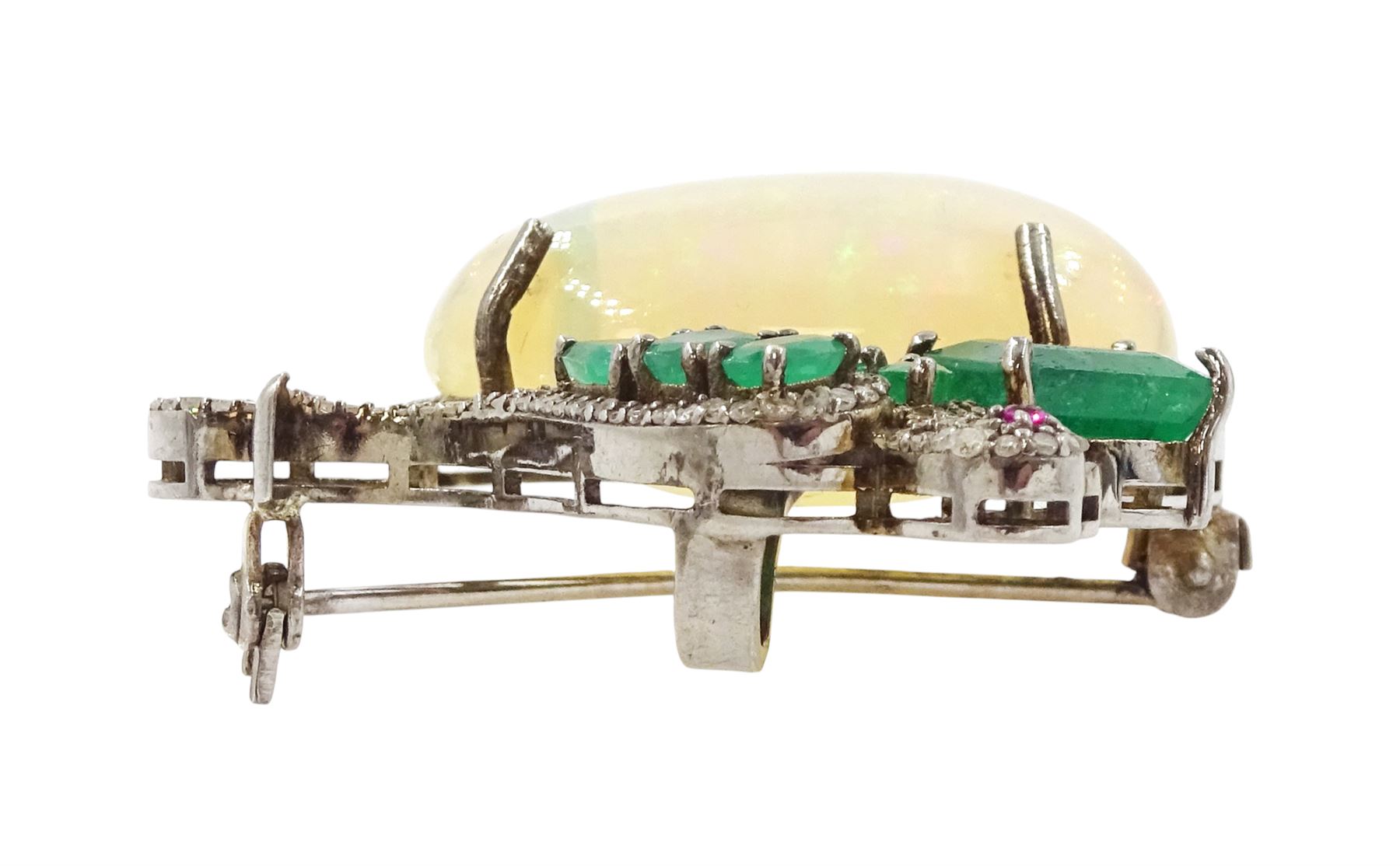 Silver opal, emerald, diamond and ruby bird pendant / brooch, emerald and diamond perched bird, on a single cabochon oval cut opal of approx 26.20 carat, total emerald weight approx 3.15 carat, total diamond weight approx 0.70 carat