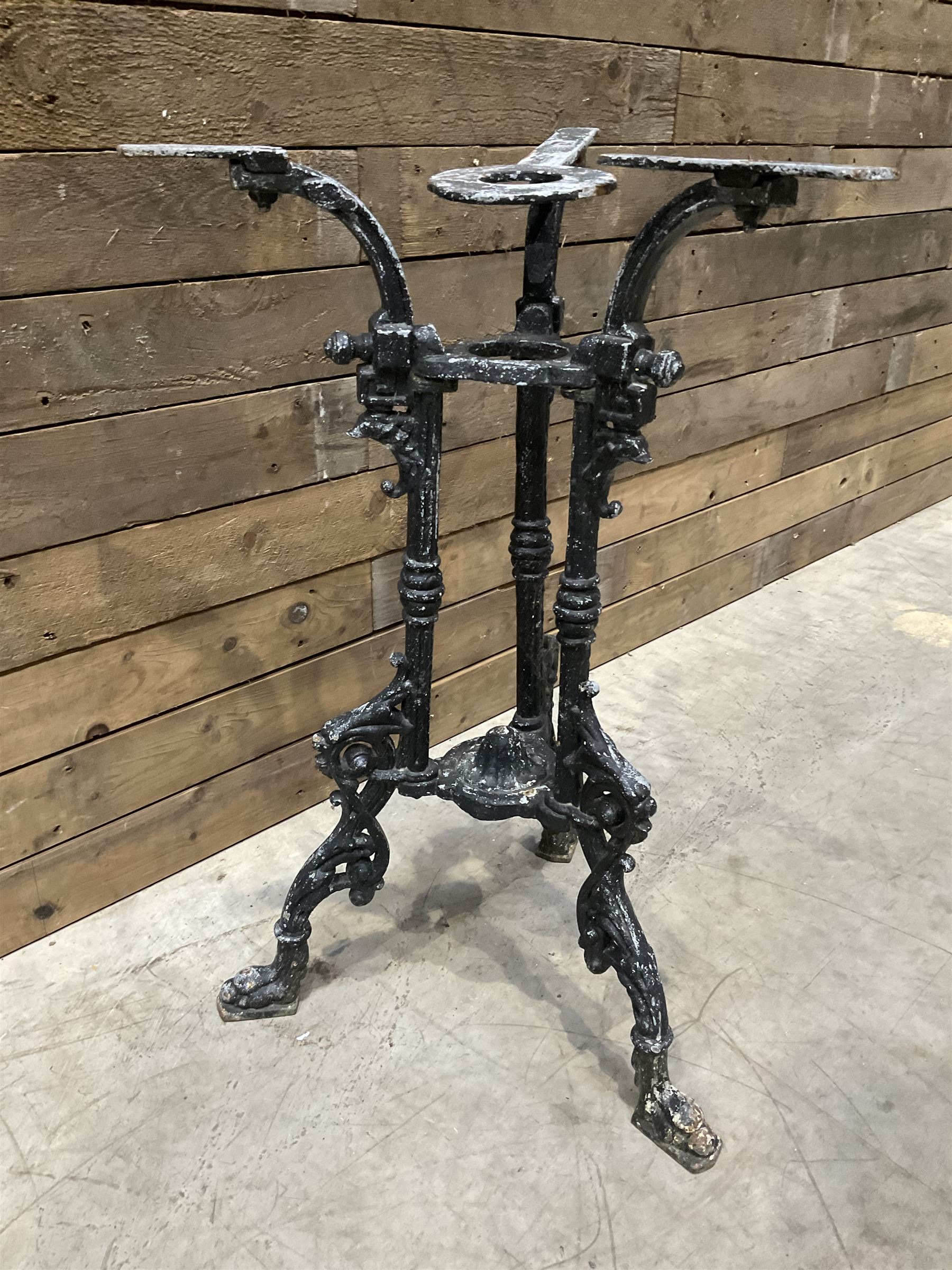 19th century cast iron table base, trefoil column with paw feet