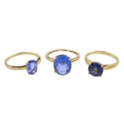 Three 9ct gold single stone blue stone set rings, all hallmarked