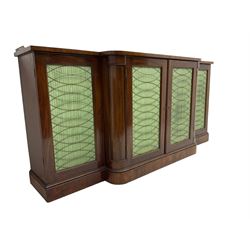 19th century mahogany break-front sideboard, raised brass gallery back with Greek key design, fitted with four cupboard doors, their pleated green fabric overlain with gilt metal grilles, lower moulded edge over plinth base