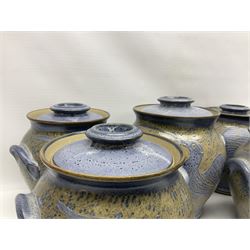 John Egerton (c1945-): set of five studio pottery stoneware twin handled jars with covers, decorated with blue birds upon a brown mottled ground, H20cm